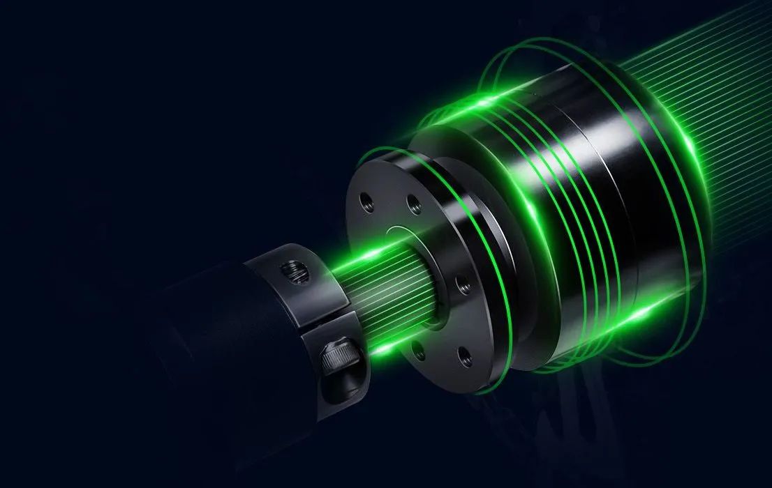 Glowing green laser beams around a metallic cylindrical device on a dark background