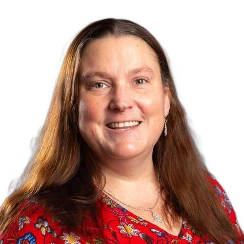 A woman in a red shirt and necklace is smiling for the camera.
