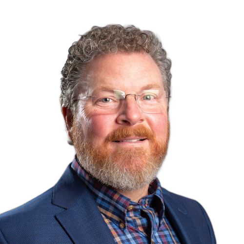 A man with a beard and glasses is wearing a blue suit and plaid shirt.