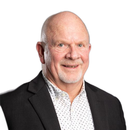 A man in a suit and polka dot shirt is smiling for the camera.
