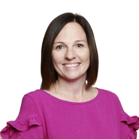 A woman in a purple shirt is smiling for the camera.