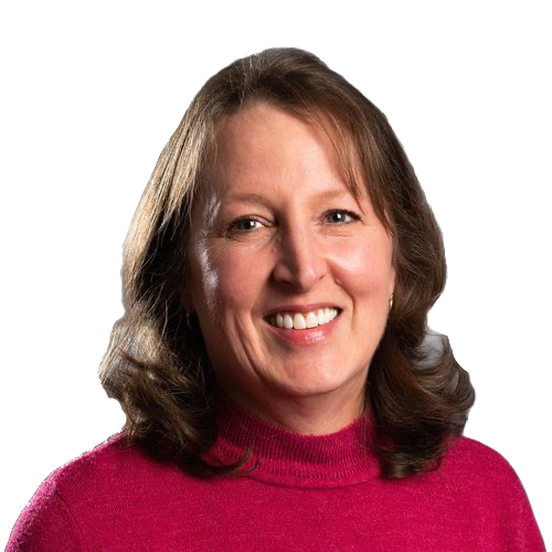 A woman in a pink sweater is smiling for the camera.