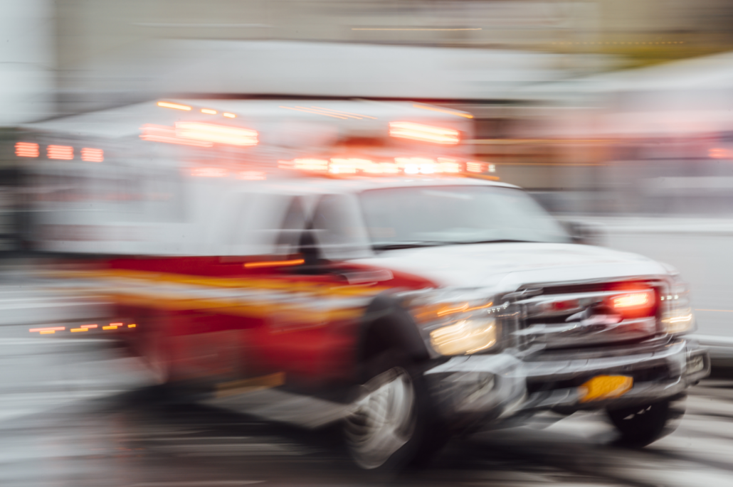 A blurry picture of an ambulance driving down a street.