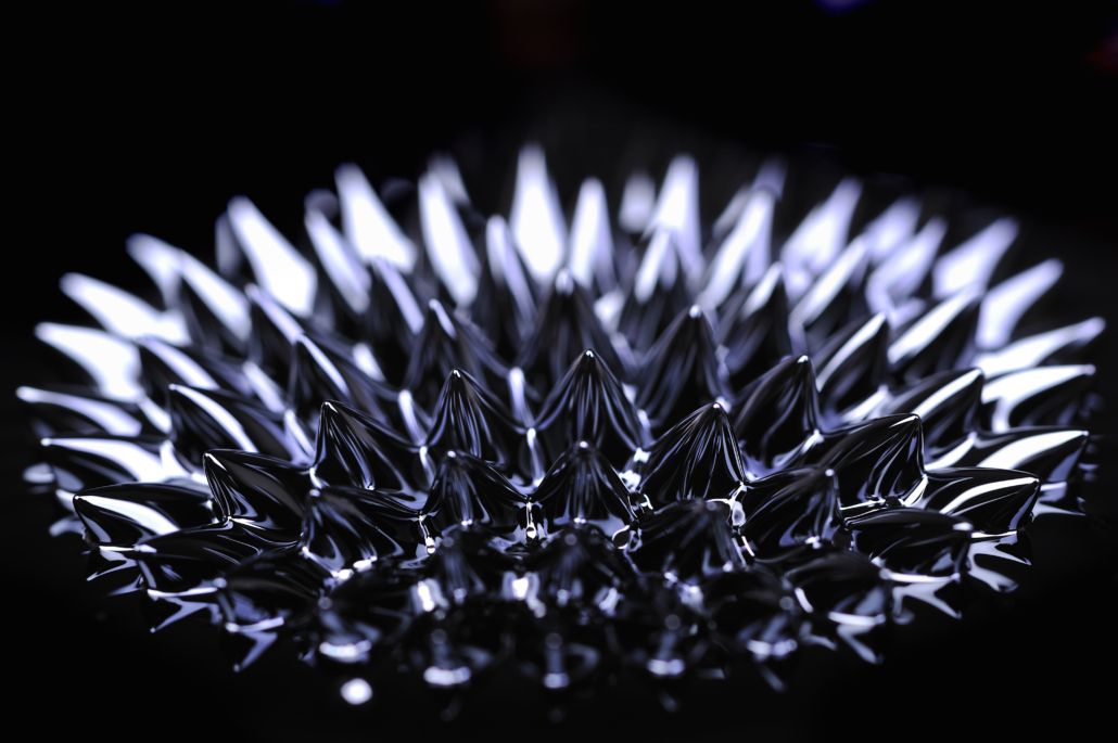 A close up of a metal object with a black background