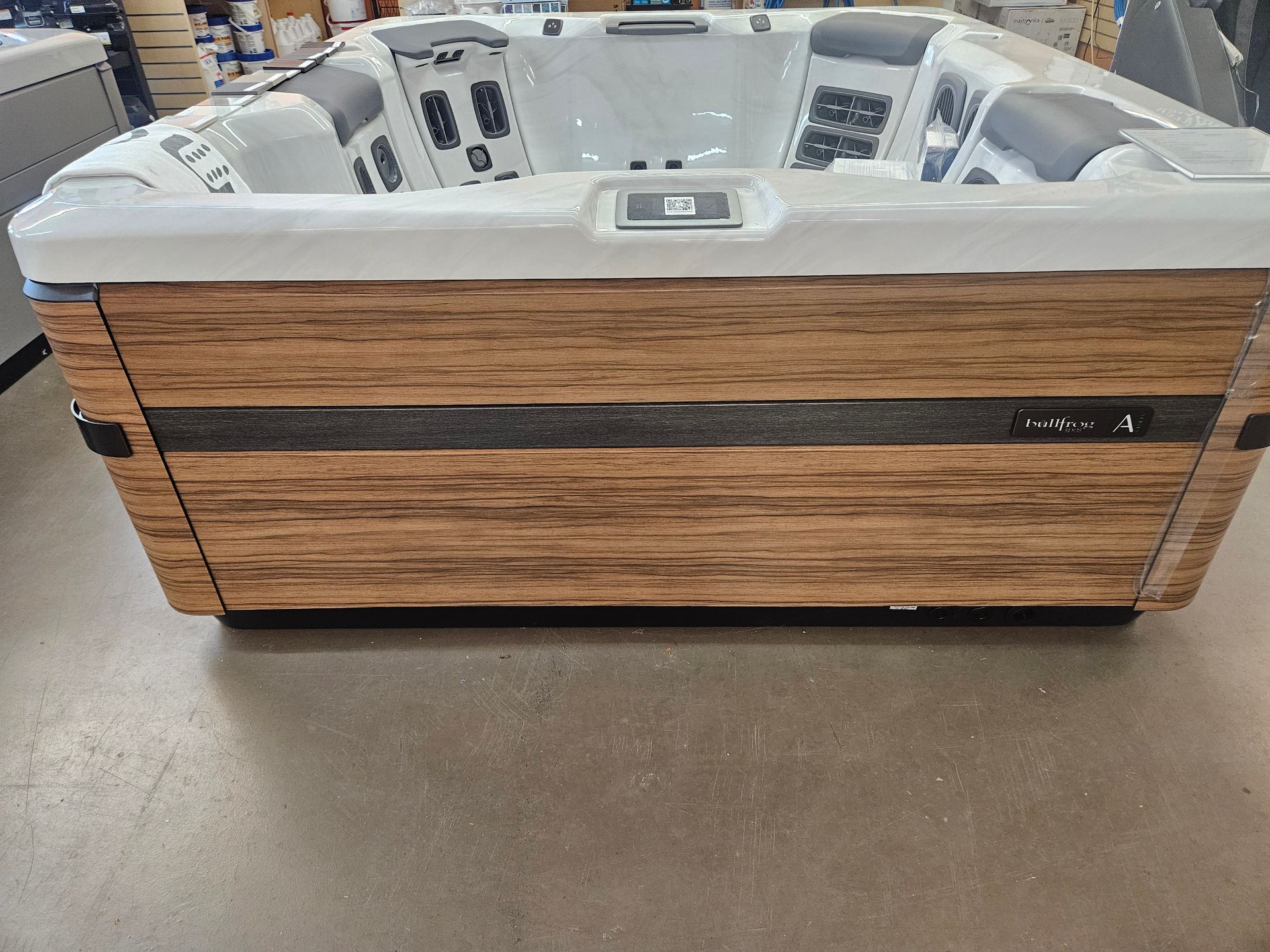A large hot tub is sitting on a table in a store.