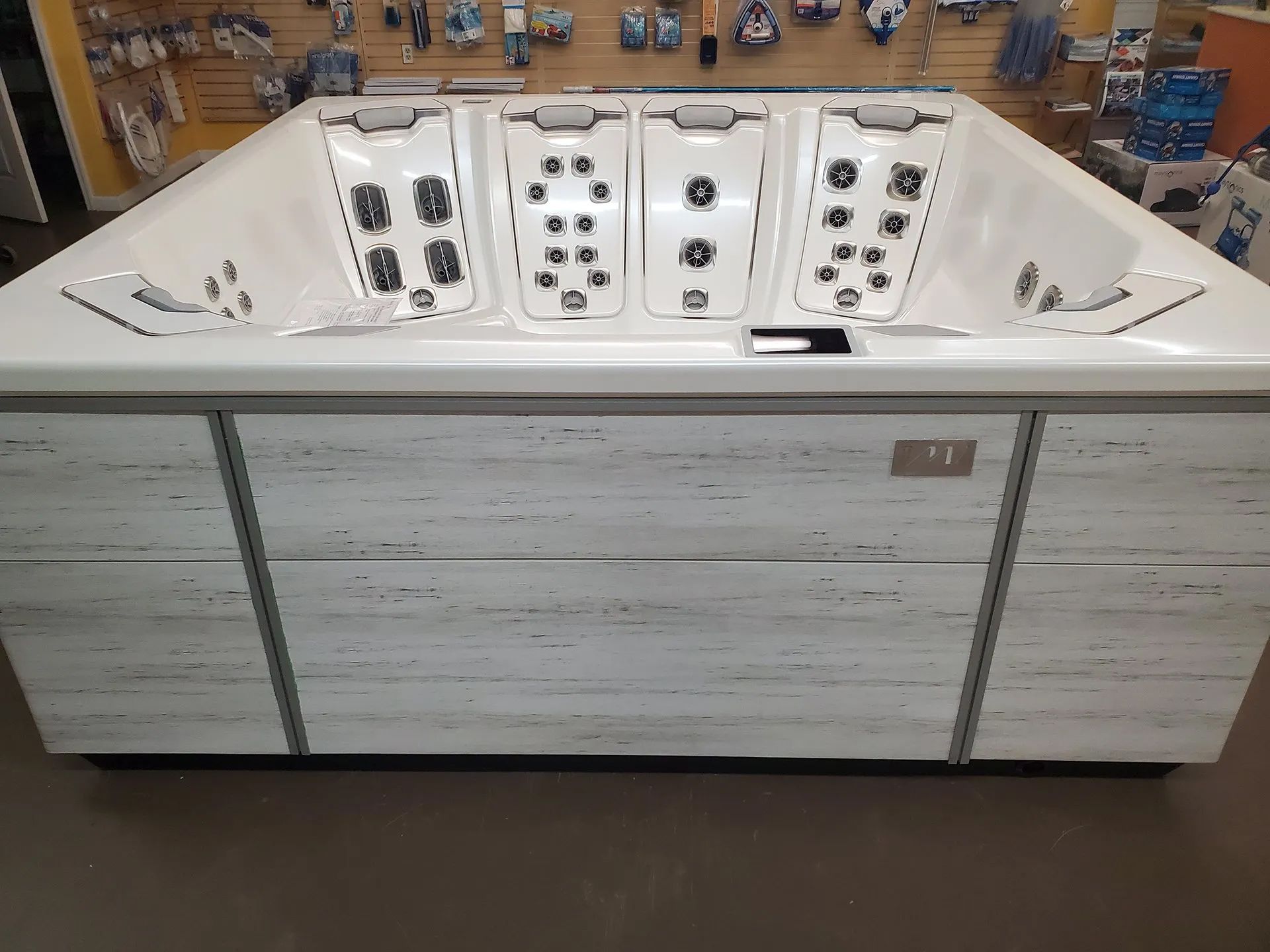 A large white hot tub is sitting in a store.