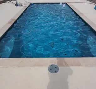 A large swimming pool filled with blue water.