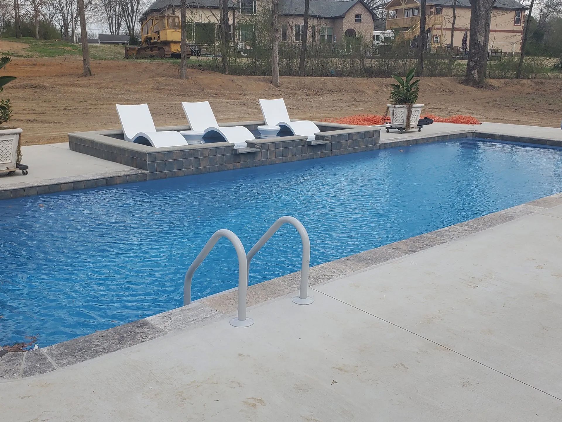 A large swimming pool with a staircase leading to it