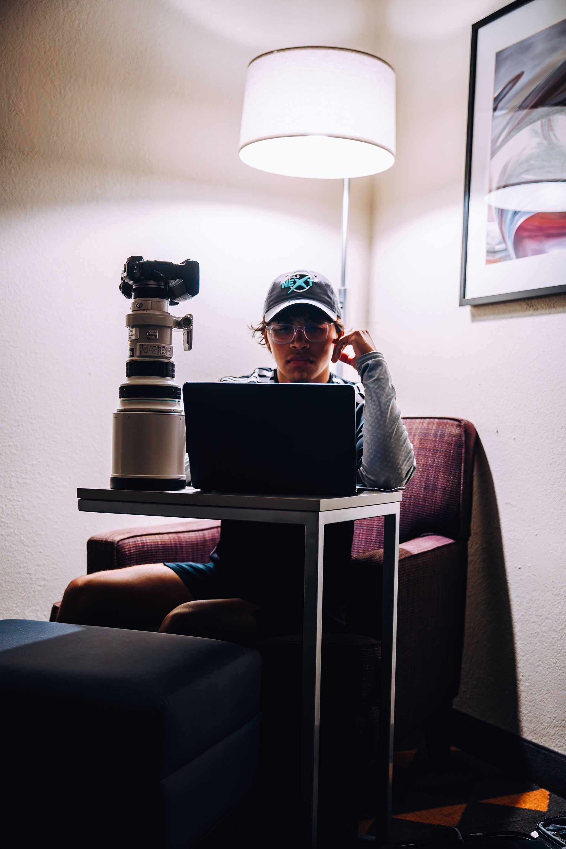 A person editing video footage of a soccer match on an ultra-wide monitor in a studio setting.