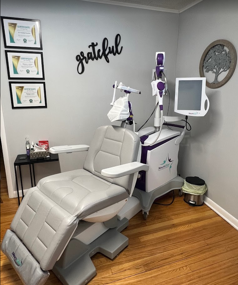 Medical chair with attached equipment in a treatment room.