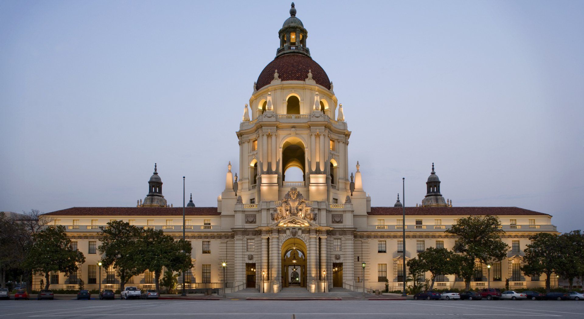 Pasadena City Hall illuminated at dusk; ornate building with a central dome and classical architecture.