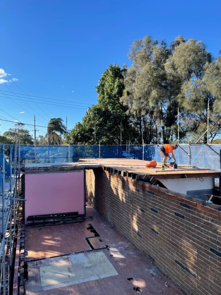 Construction Site With Worker on a Partially Demolished Building — ALI Civil Pty Ltd in South Nowra, NSW