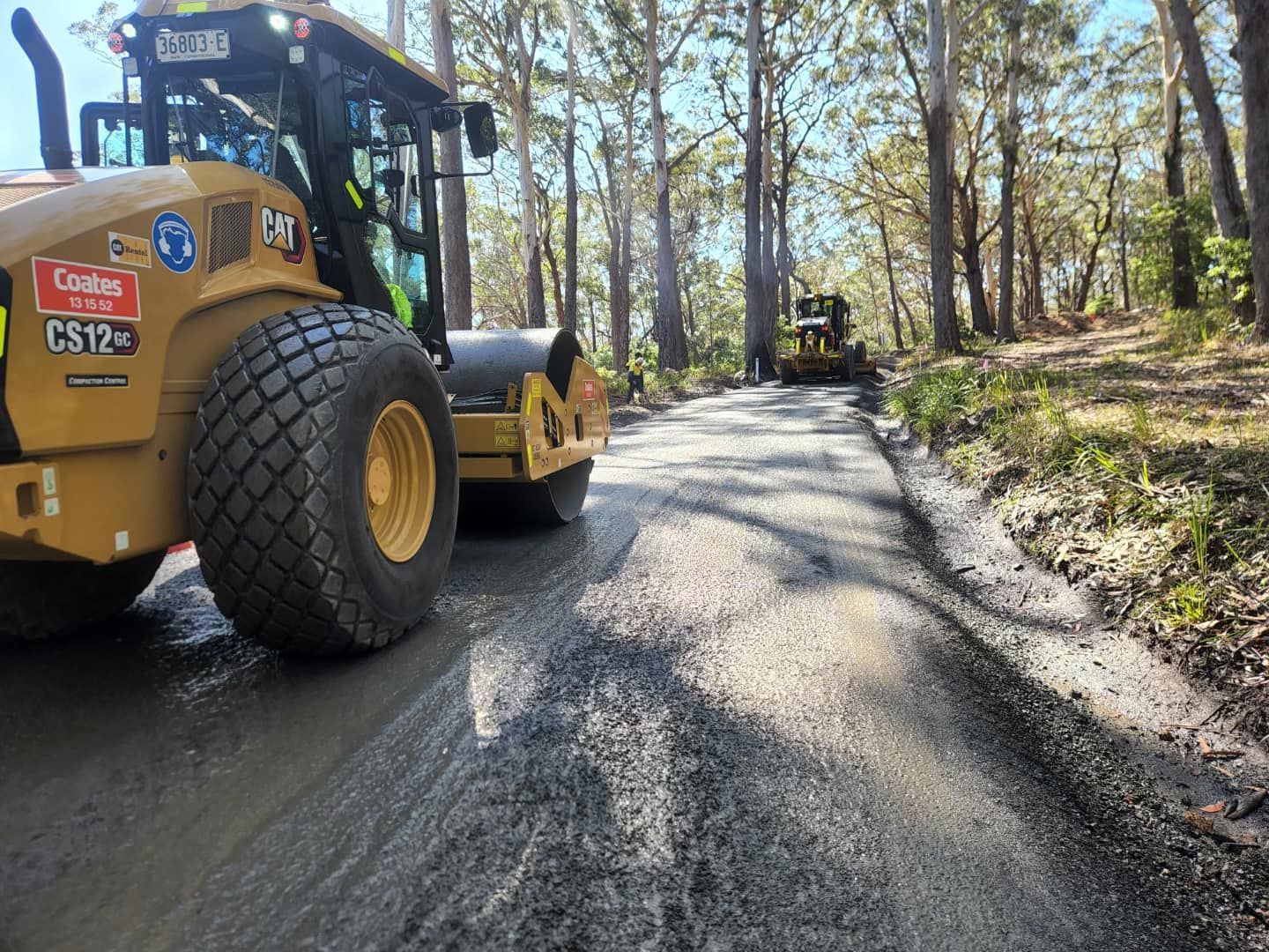 Road Roller Compacting Asphalt on A Forest Road — ALI Civil Pty Ltd in Jervis Bay, NSW