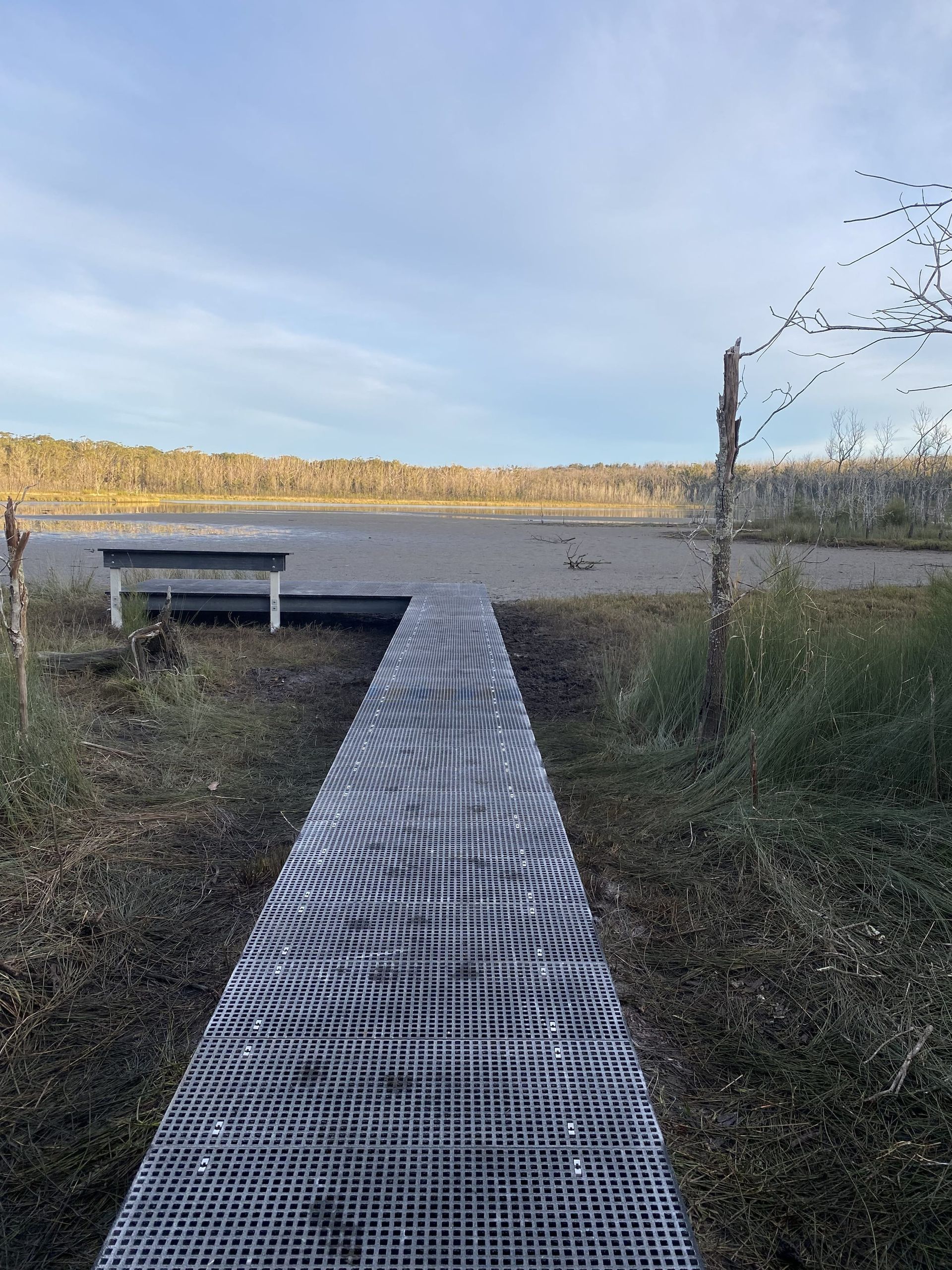 Metal Walkway Leading to A Bench Overlooking a Body of Water — ALI Civil Pty Ltd in South Nowra, NSW