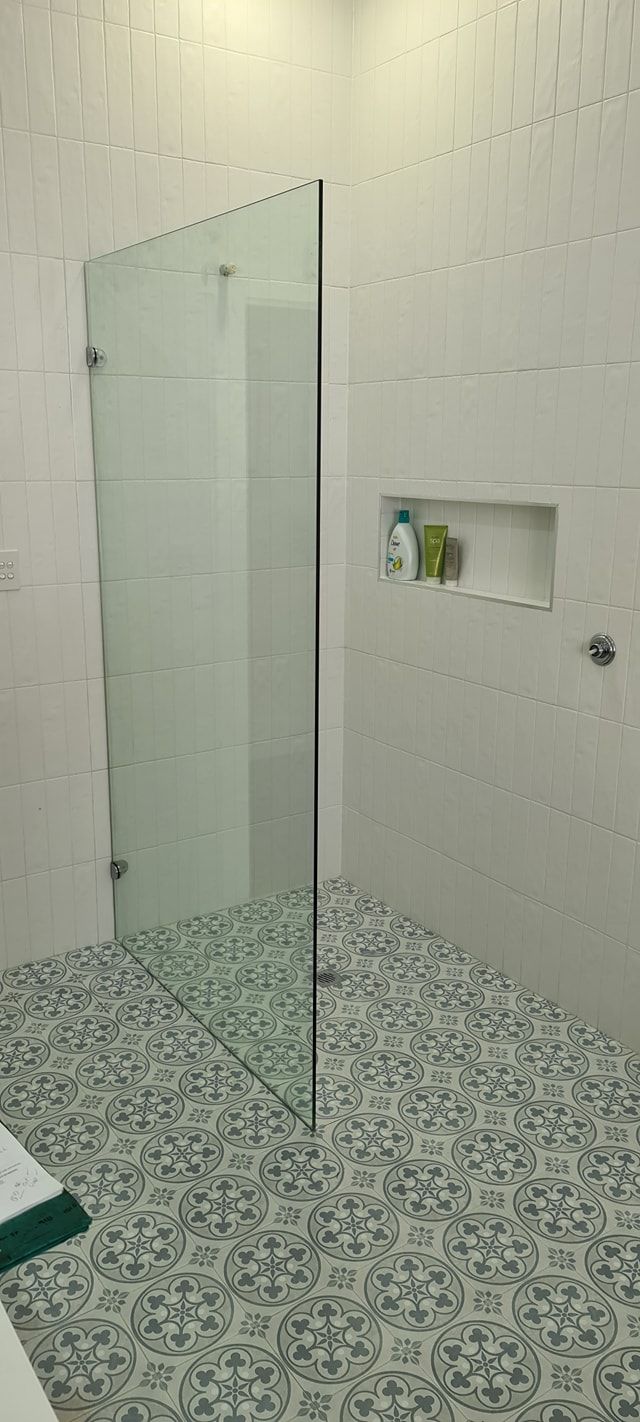 A bathroom with a quality shower screen walk in shower with a glass door.