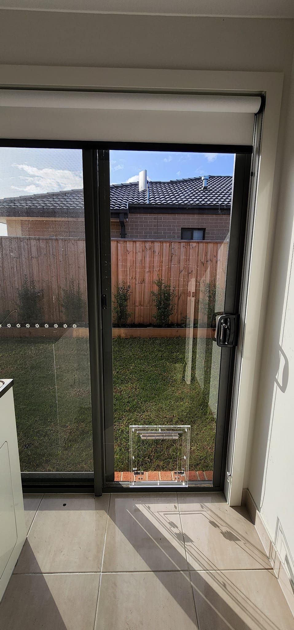 A room with a sliding glass door leading to a backyard.