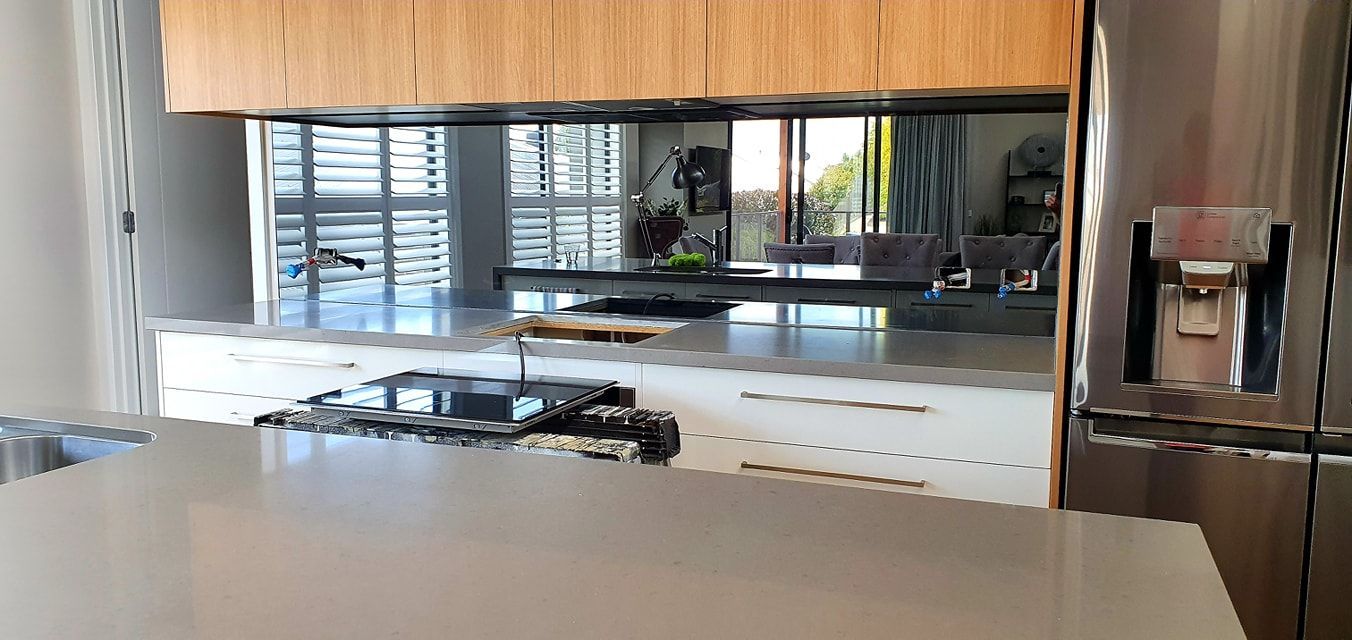 A kitchen with stainless steel appliances , wooden cabinets , a refrigerator and a sink.