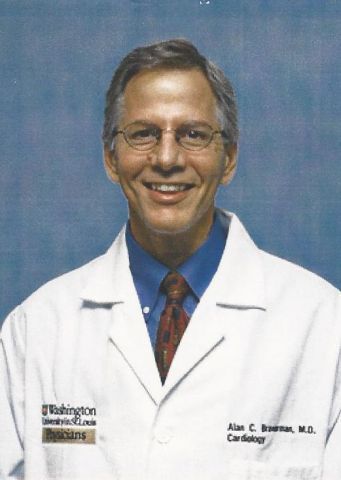 A man in a lab coat with the name alan on it