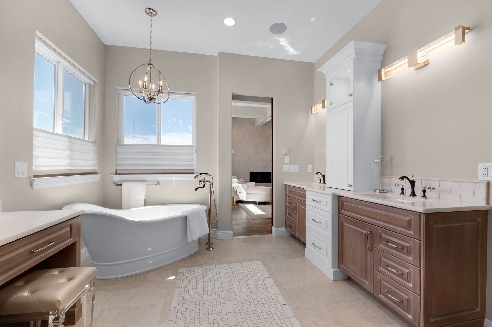 Bathroom with freestanding tub, double vanity, and a view into a bedroom.