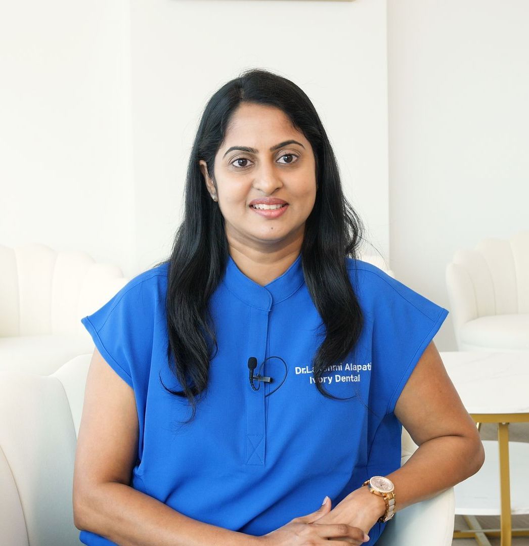 A woman in a blue shirt is sitting in a chair