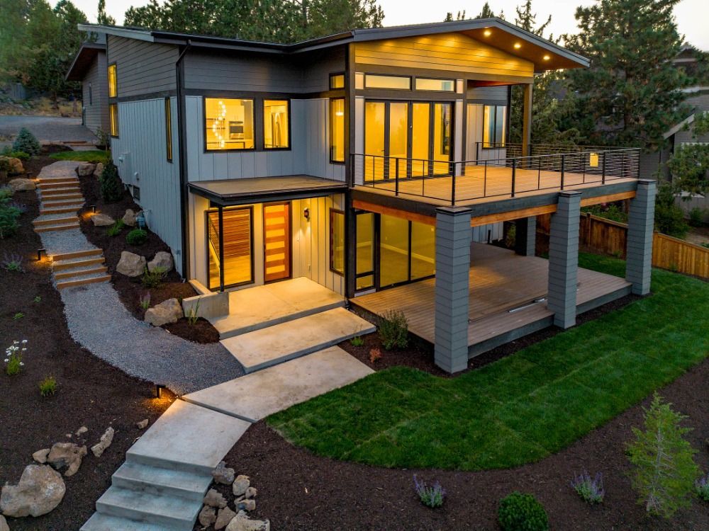 An aerial view of a modern house with a large deck.