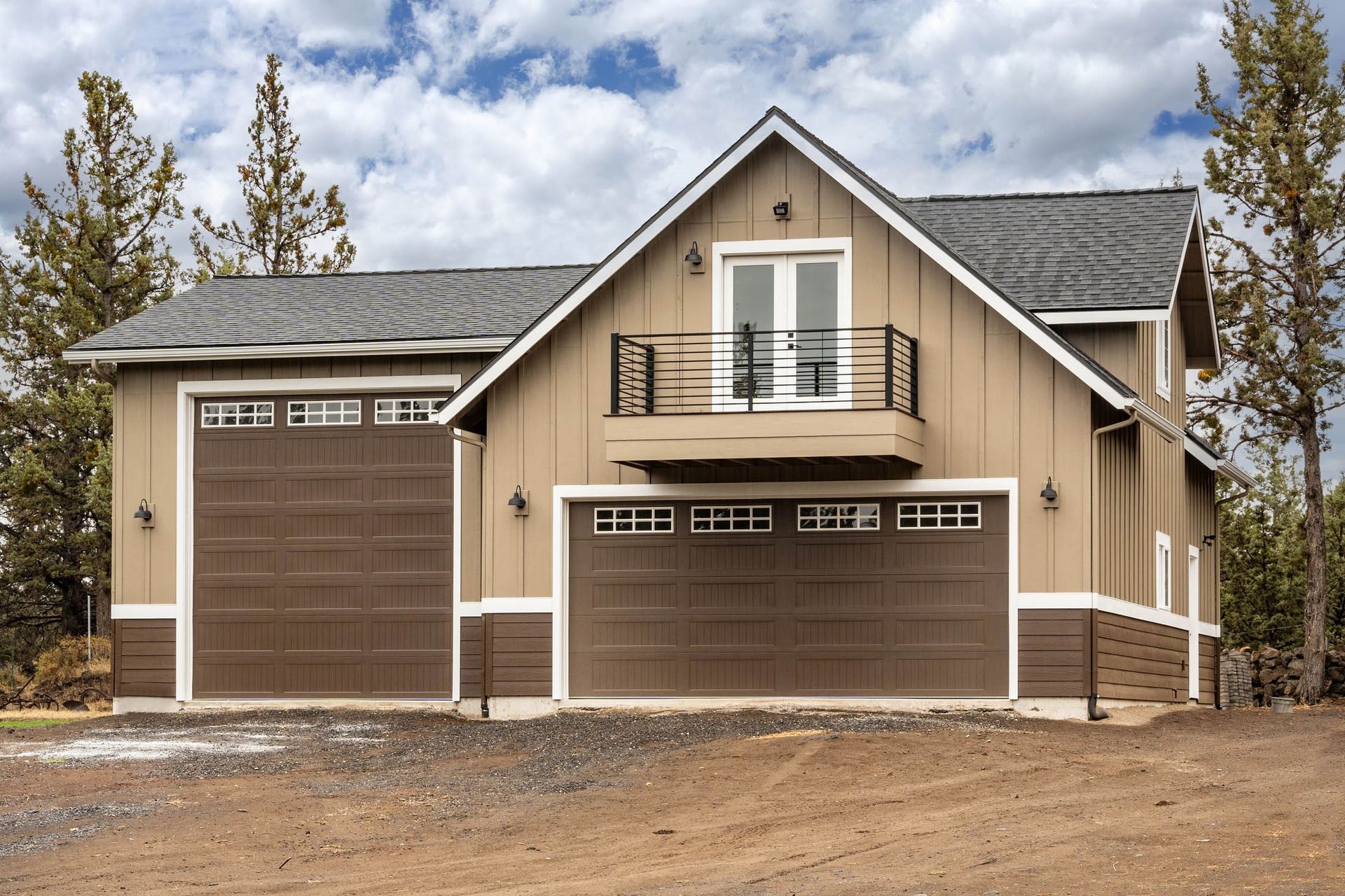 A house with two garage doors and a balcony