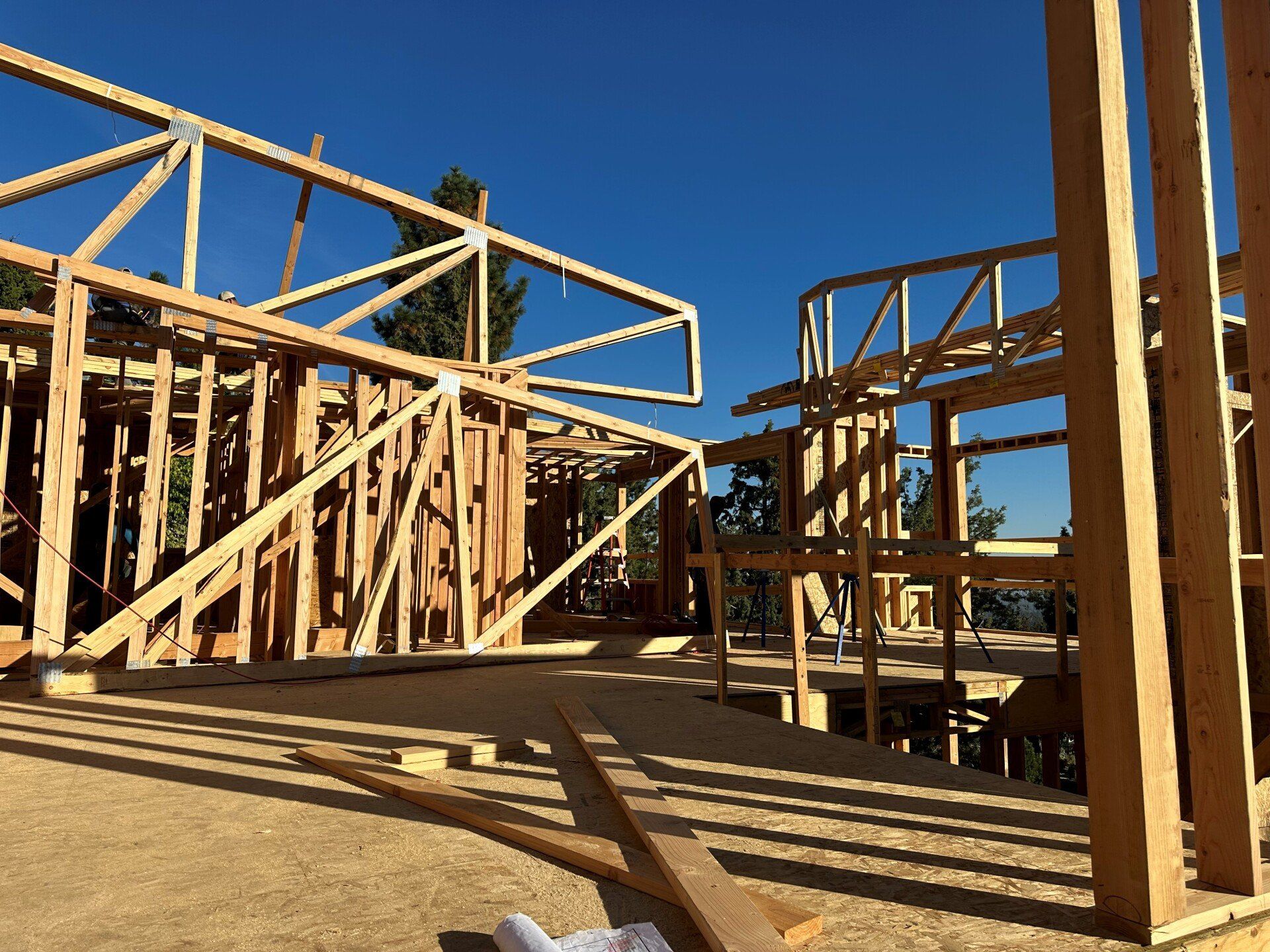 A large wooden structure under construction with a blue sky in the background