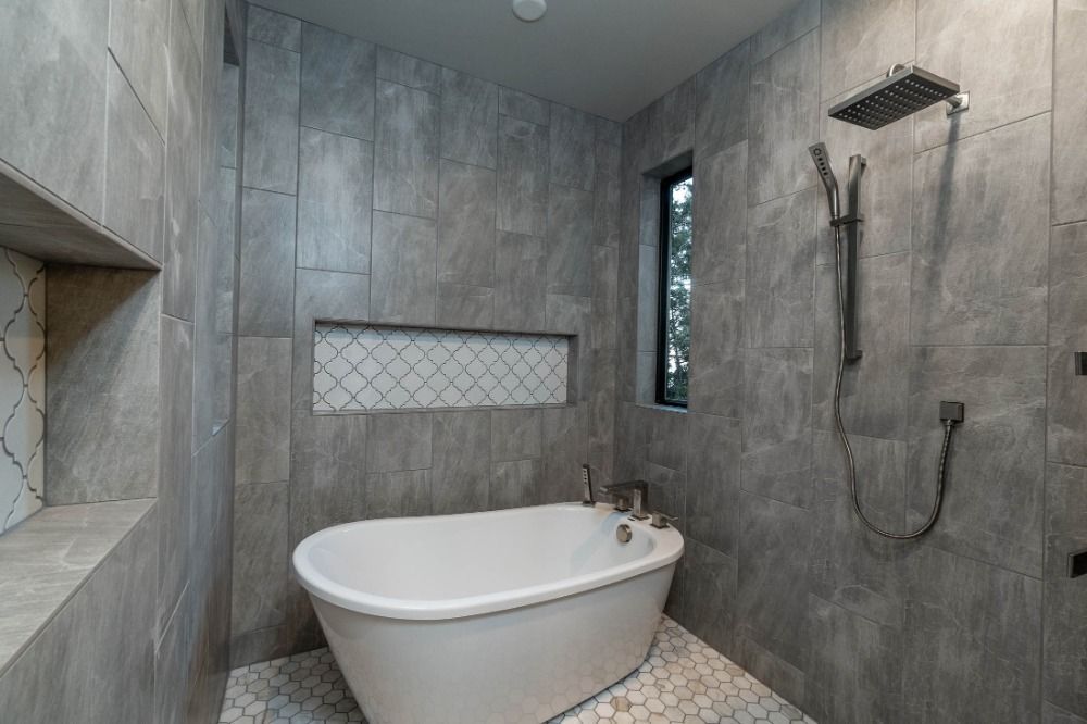 A bathroom with a bathtub and a shower.
