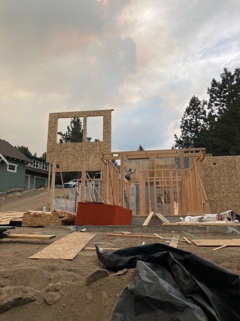 A house is being built in the middle of a dirt field