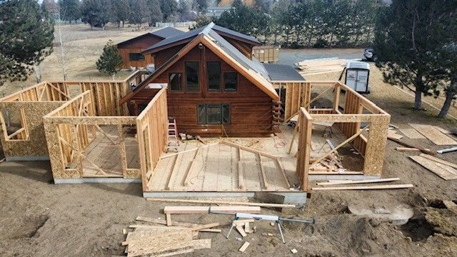 An aerial view of a log cabin under construction.