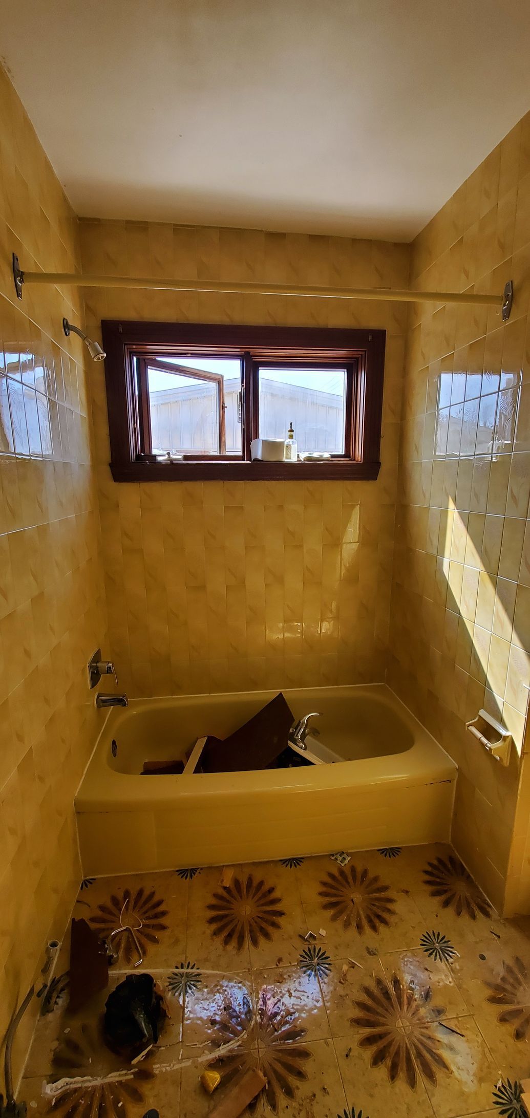 A bathroom with a bathtub and a window.