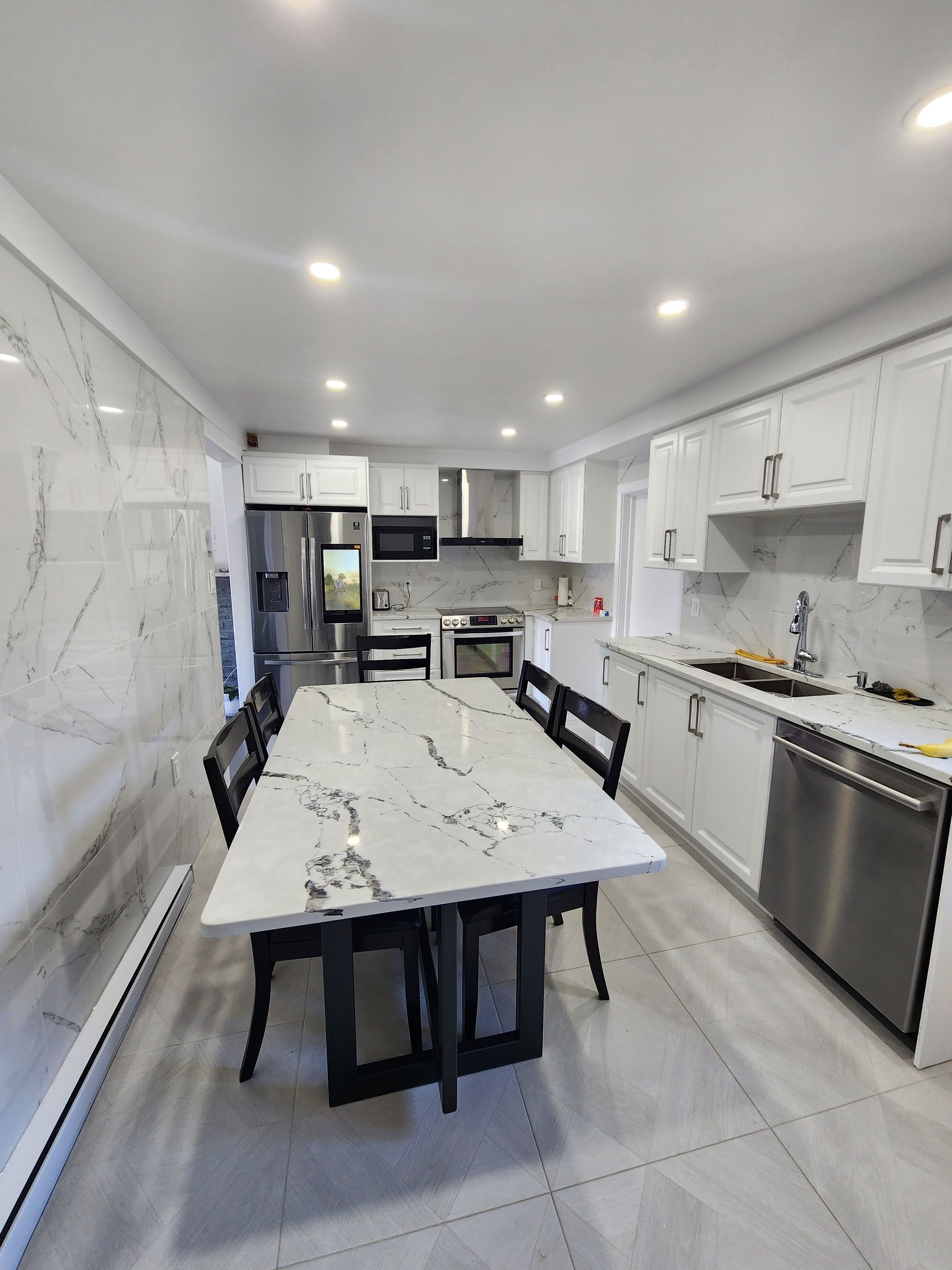 A kitchen with a table and chairs in it