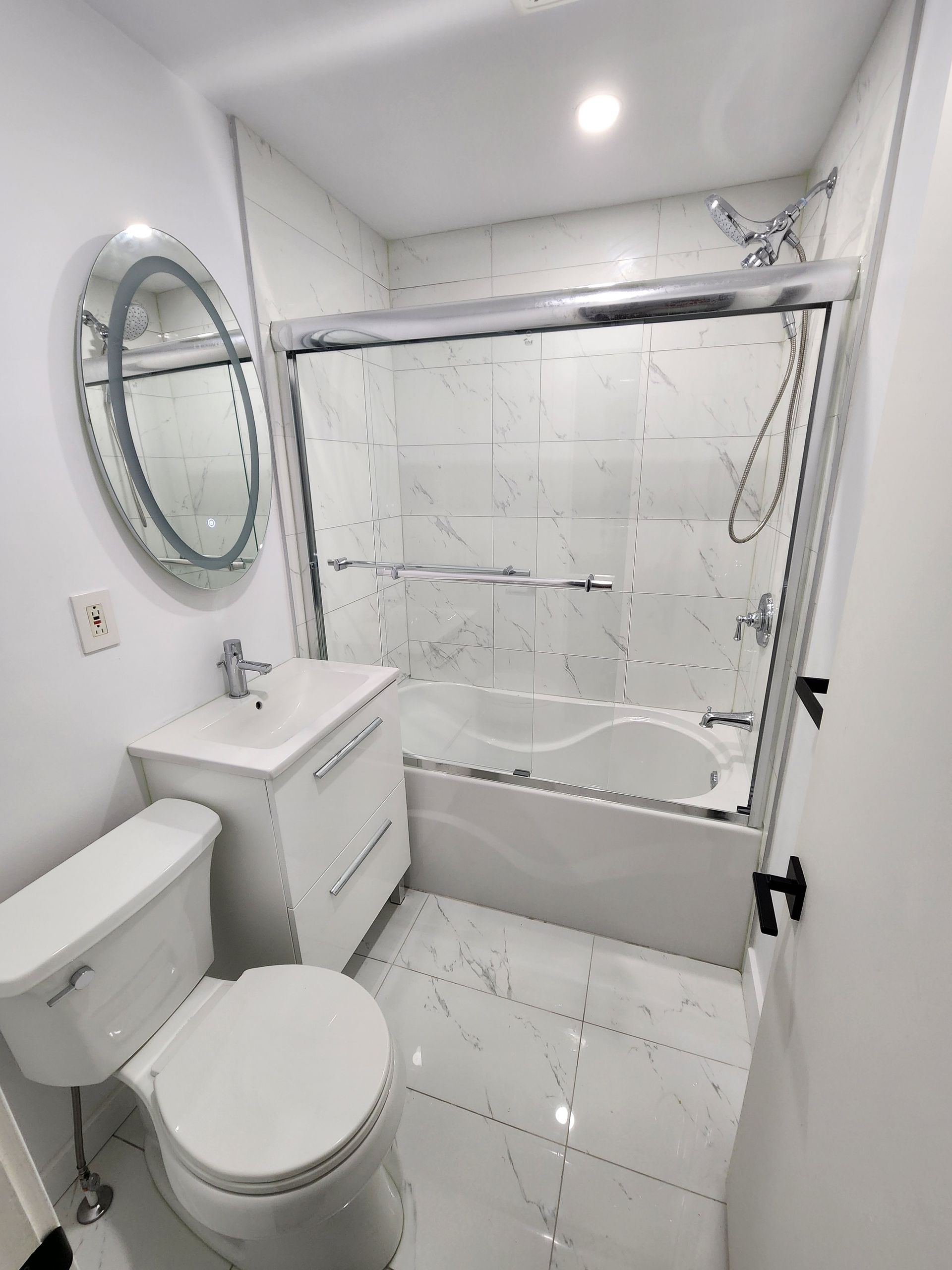 A bathroom with a toilet , sink , and bathtub.