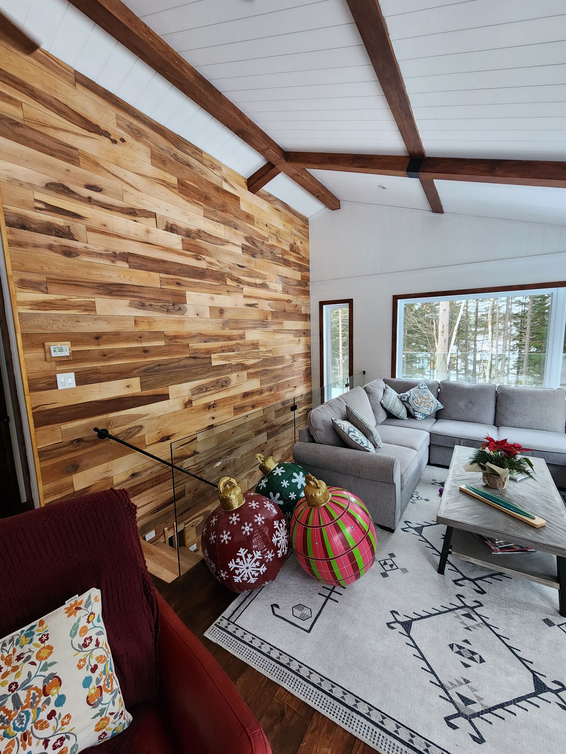 A living room filled with furniture and a wooden wall.
