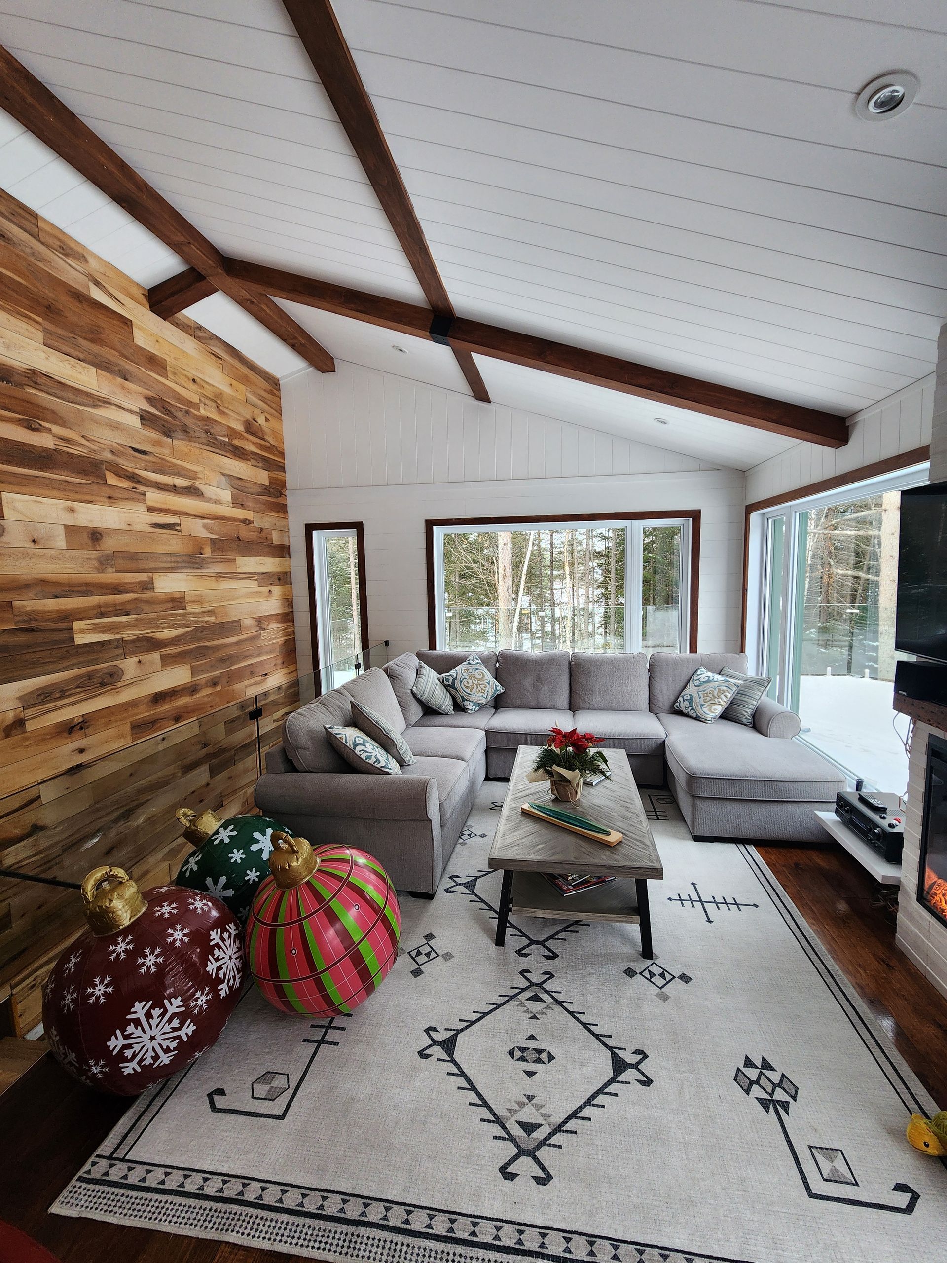 A living room with a sectional couch and a rug