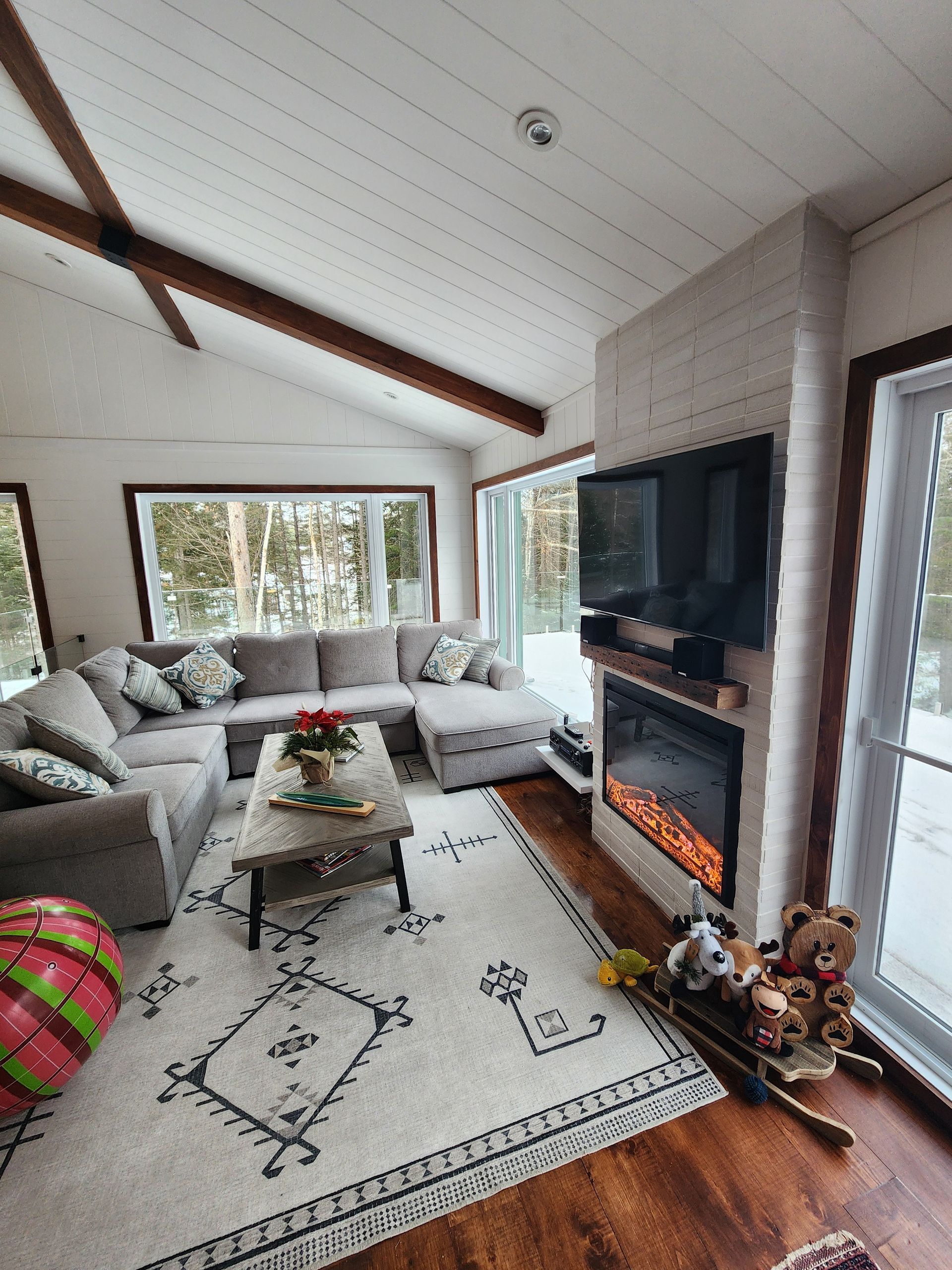 A living room with a couch , fireplace and television.