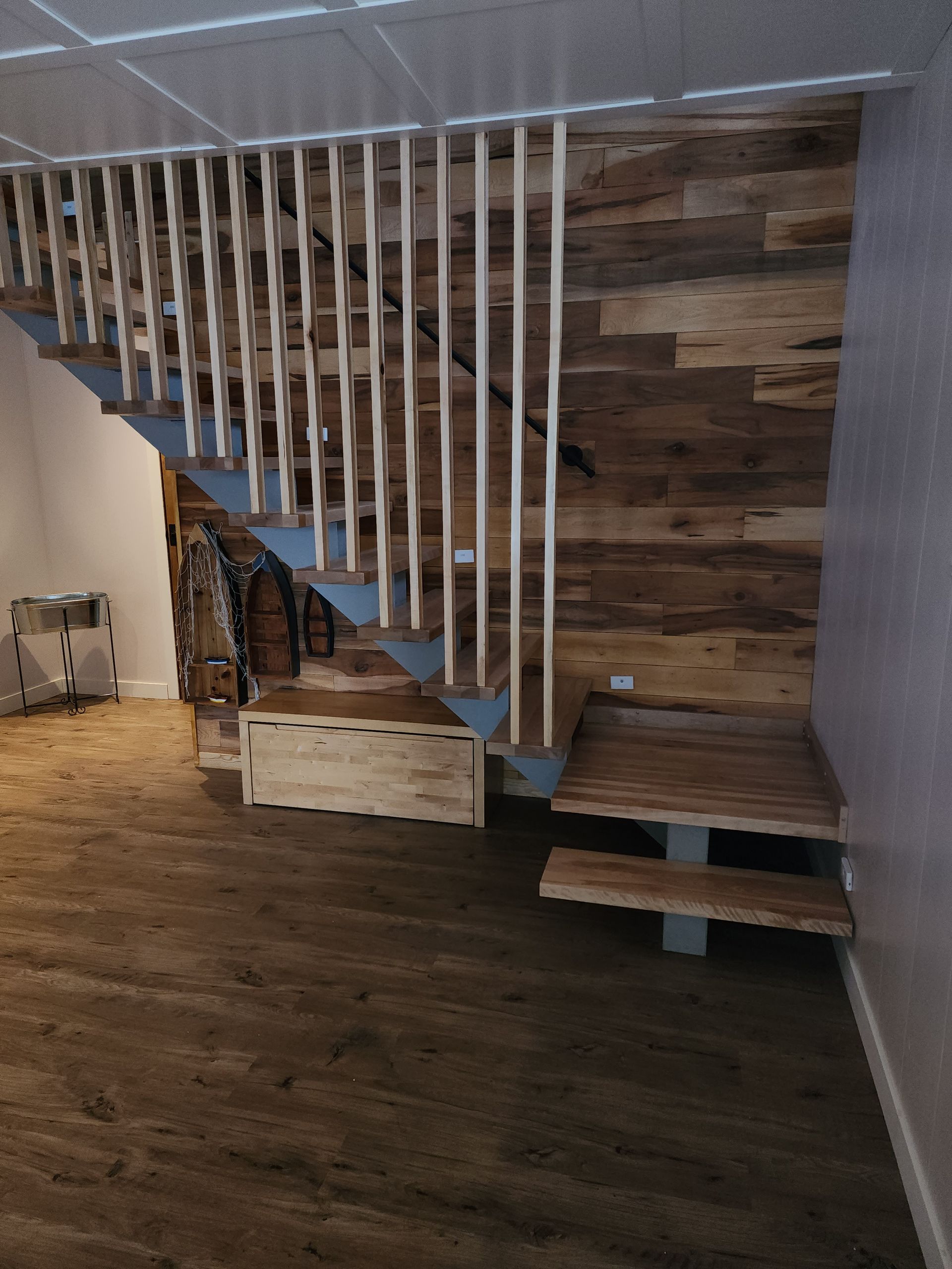 A wooden staircase with a blue railing in a room