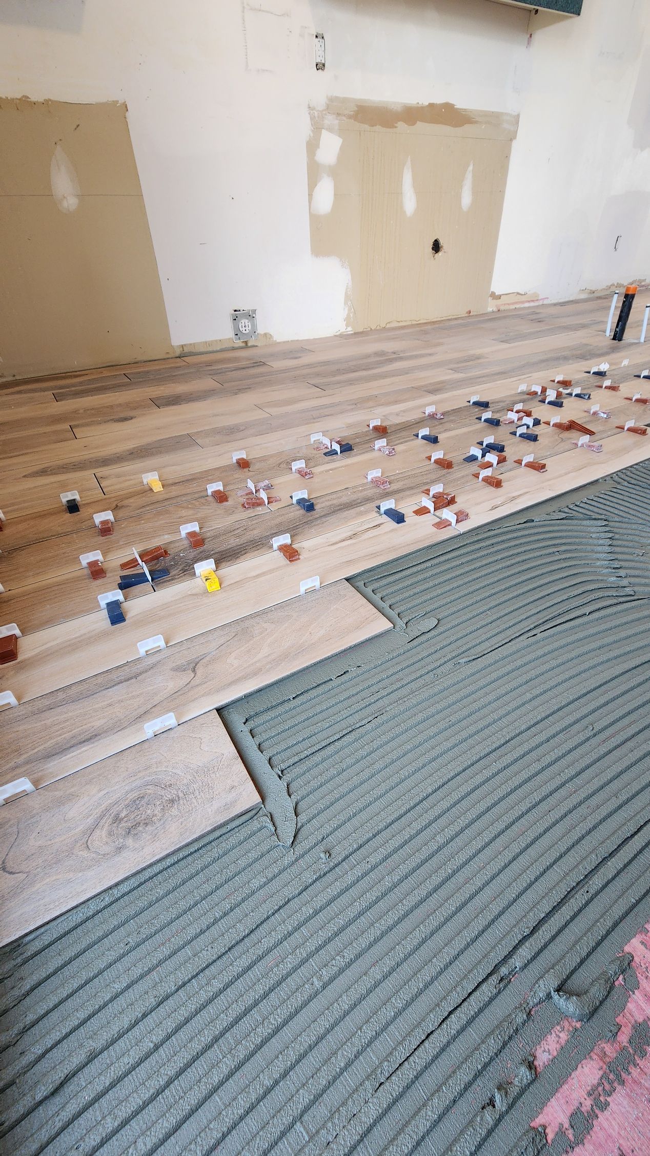 A room with a lot of tiles on the floor.