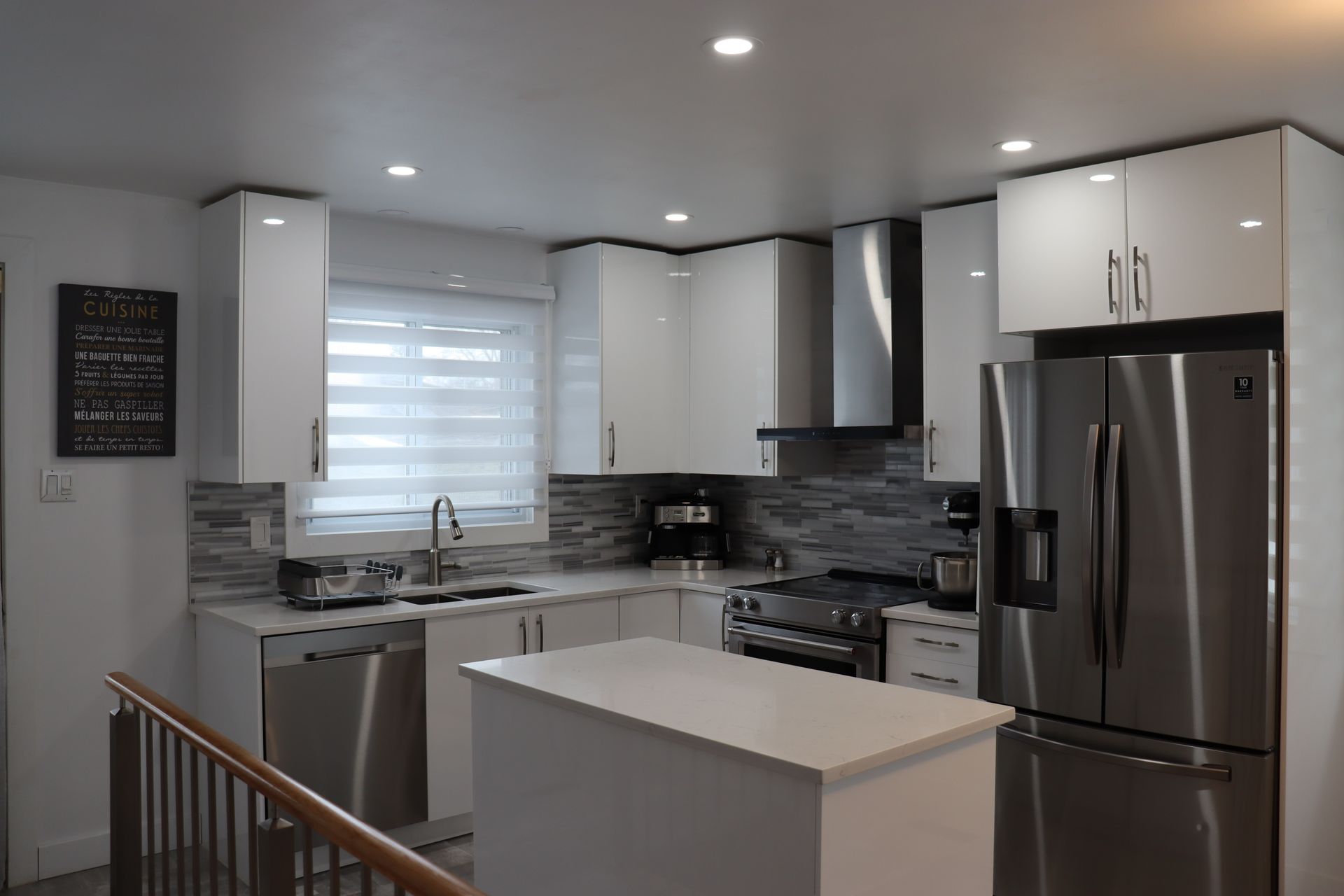 A kitchen with stainless steel appliances and white cabinets