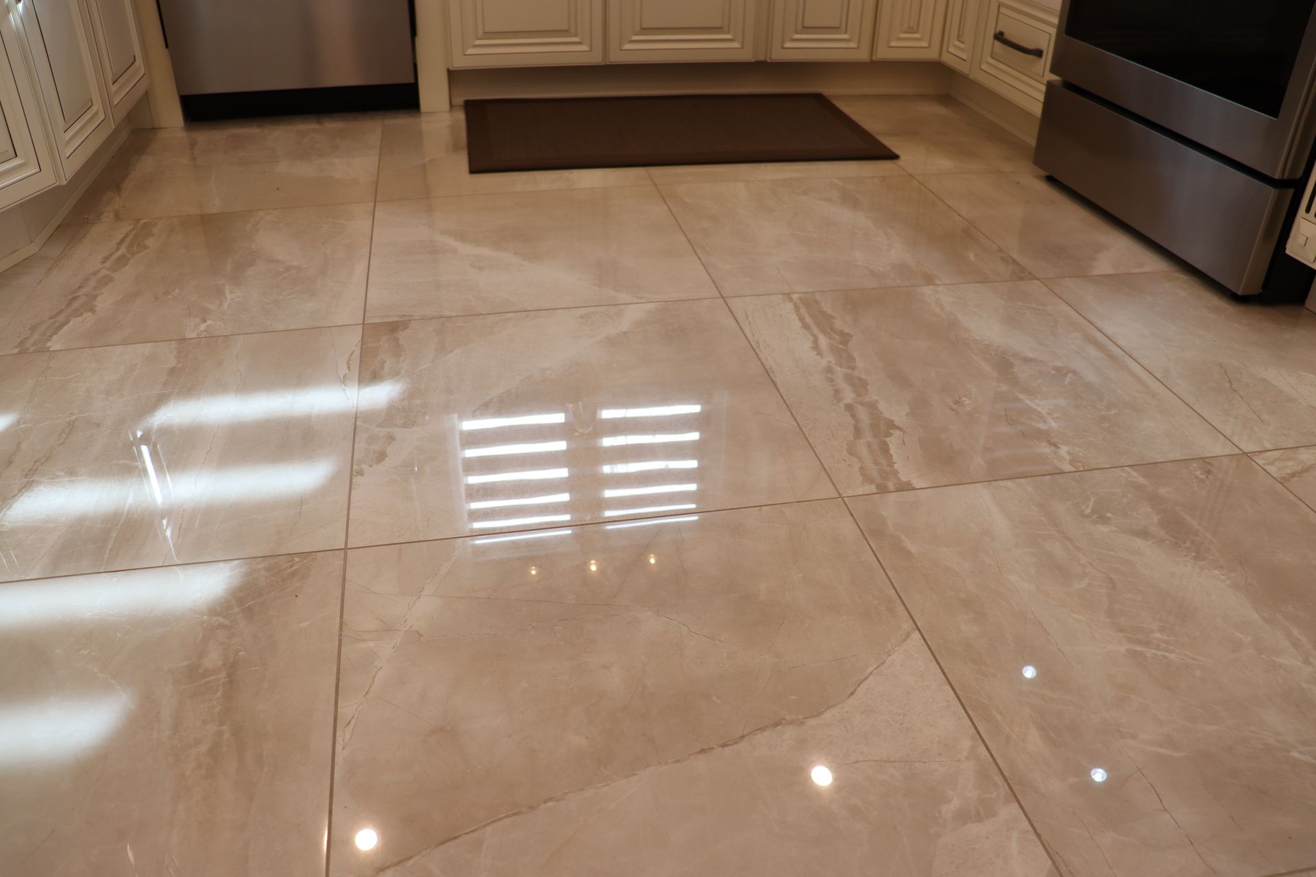 A kitchen with a tiled floor and a stove.