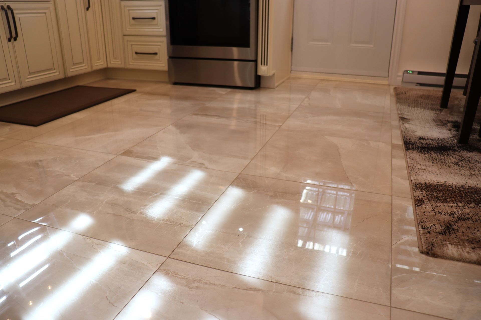 A kitchen with a tiled floor and a stove.