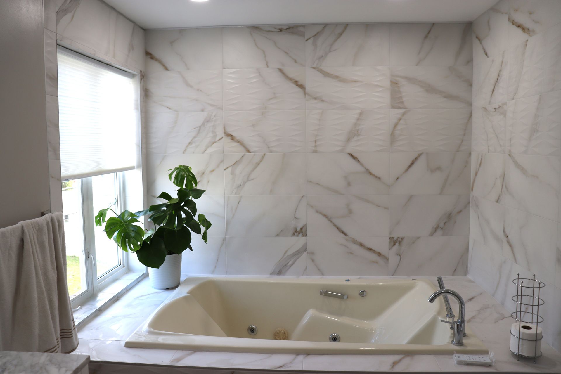 A bathroom with a jacuzzi tub and a window