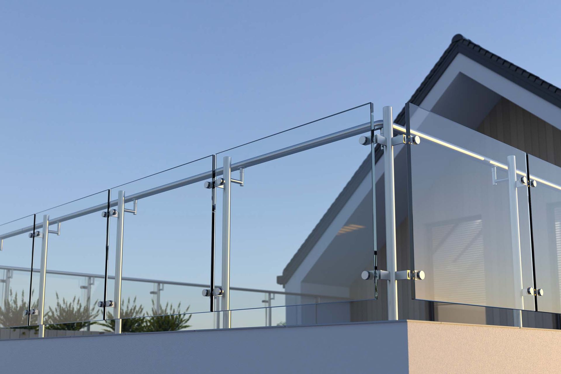 Glass railing on a modern rooftop terrace beside a house under a clear blue sky