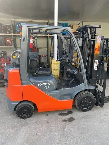 Orange and gray Toyota forklift in an industrial setting.