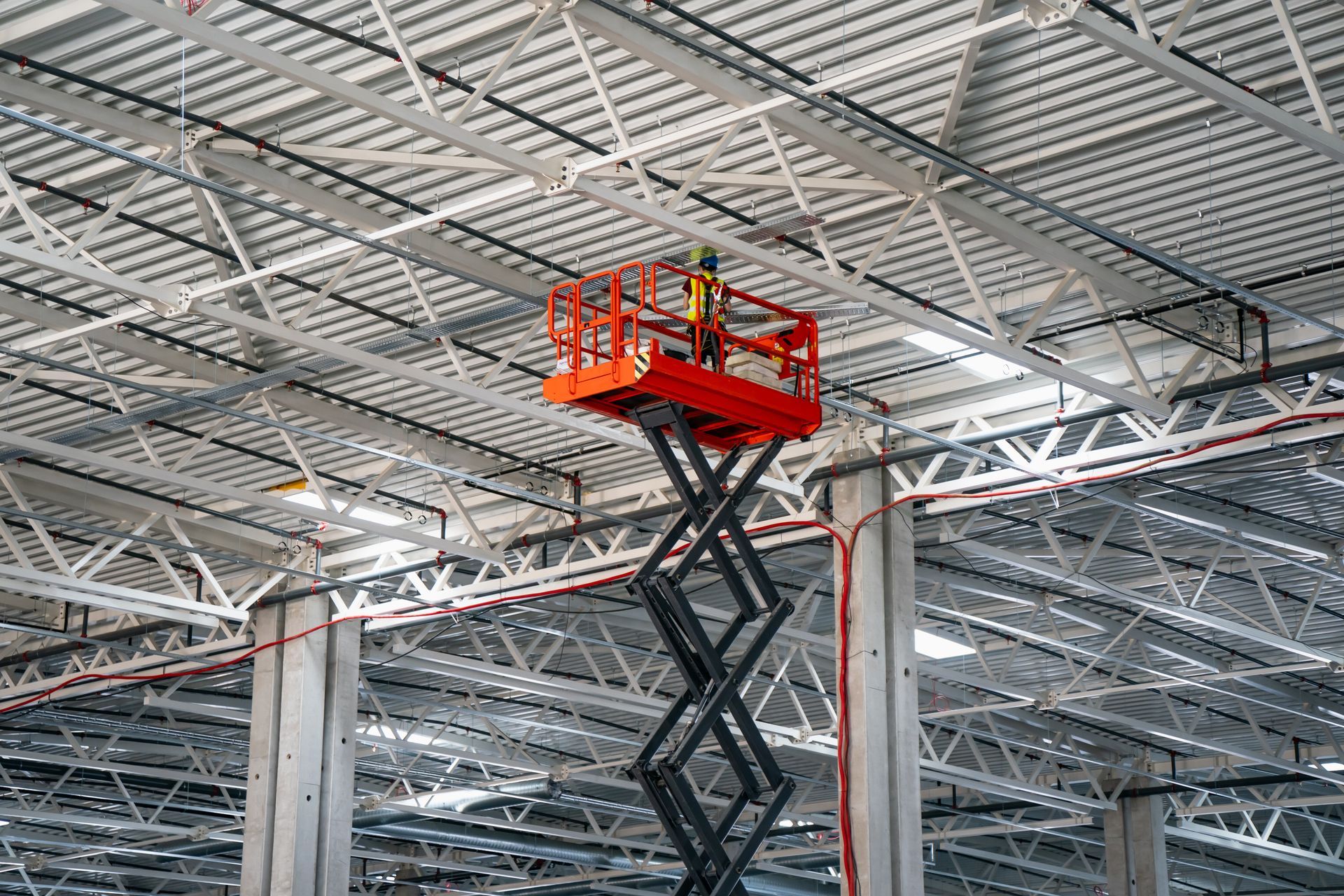 Red forklift carrying cardboard boxes in a warehouse. Red forklift carrying cardboard boxes in a warehouse.