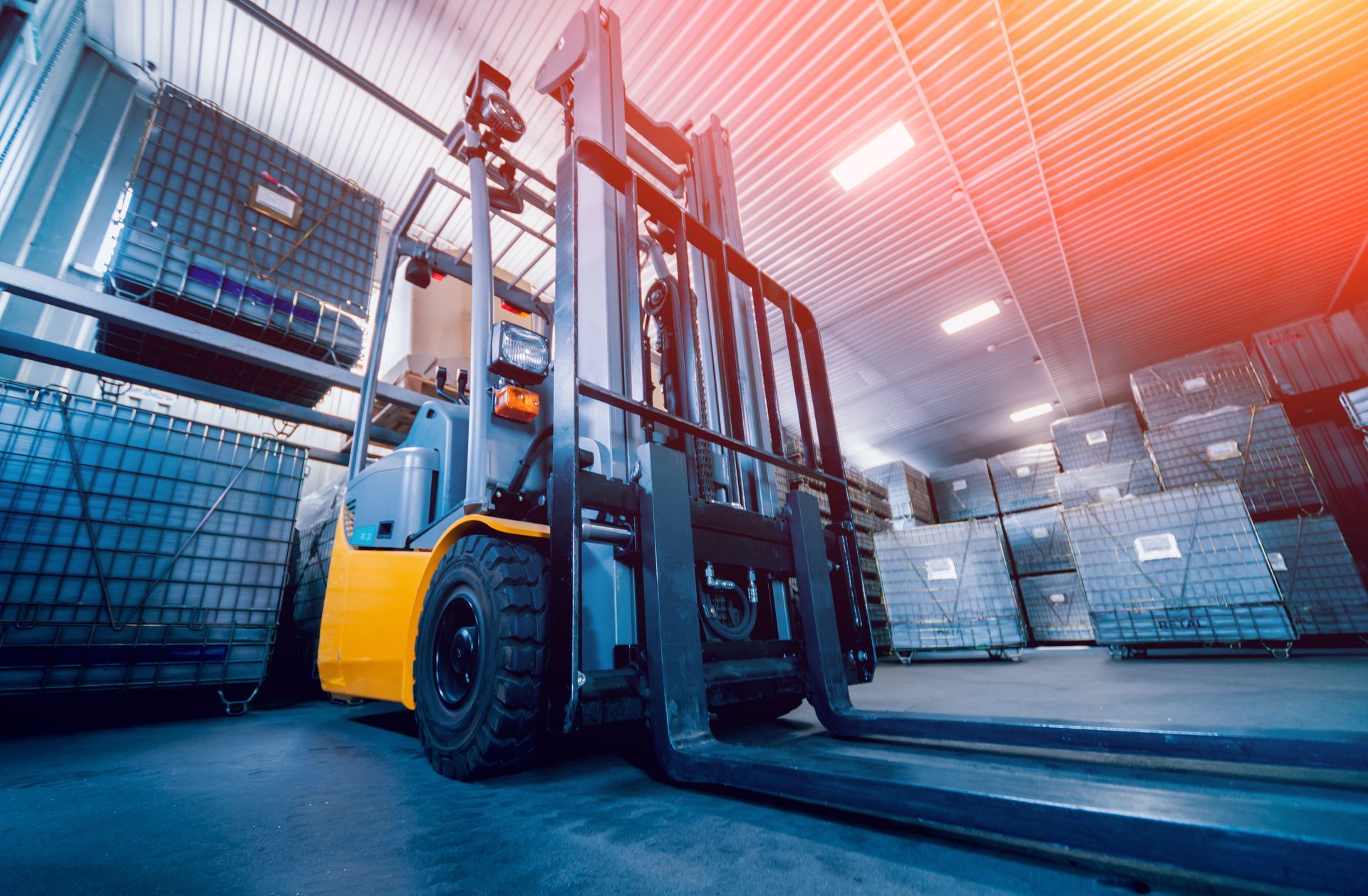 Yellow forklift in a warehouse, loading goods onto shelves. Bright lighting and stacks of cargo visible. Yellow forklift in a warehouse, loading goods onto shelves. Bright lighting and stacks of cargo visible.