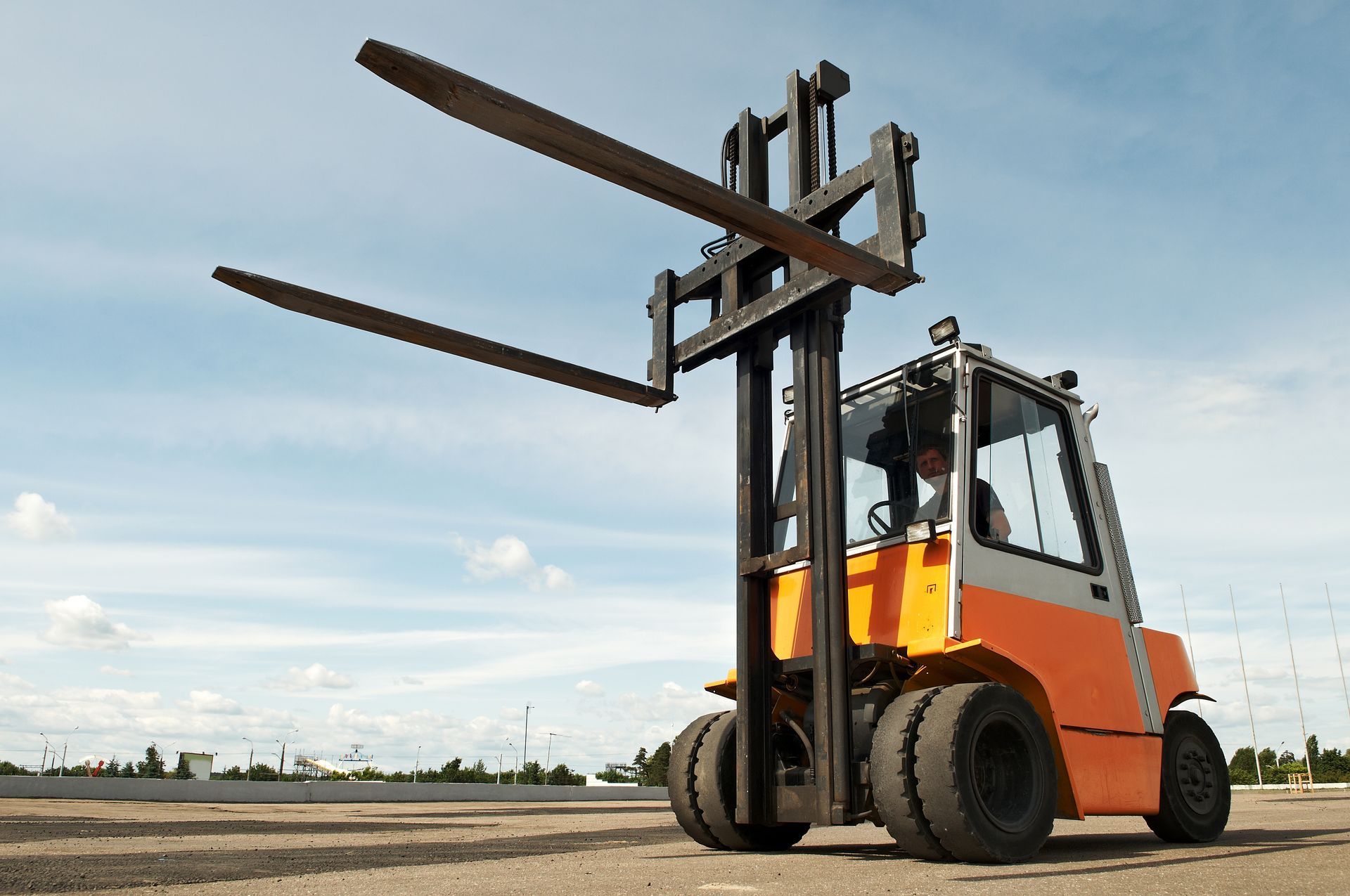 Rental forklift positioned outdoors for material handling.