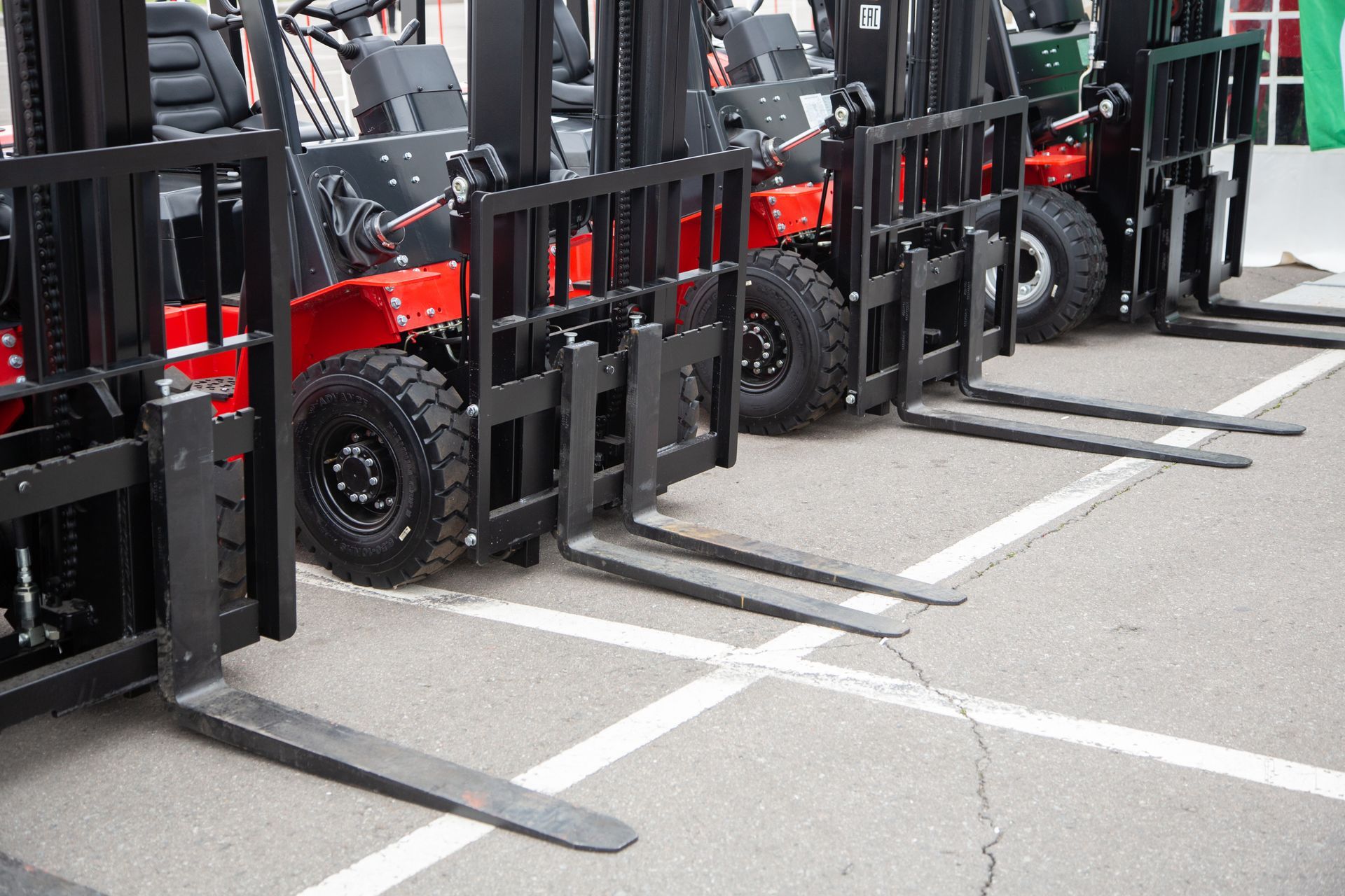 Row of red used forklifts parked