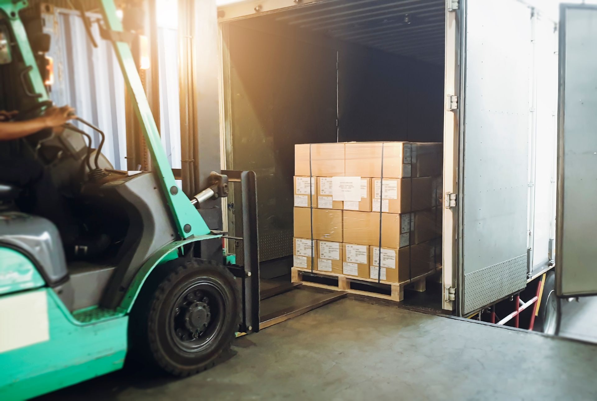 Forklift loading a pallet into a trailer
