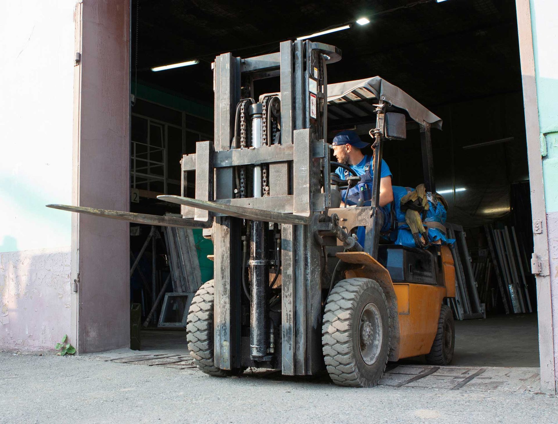 Industrial worker in a hard hat receiving training on a high-quality rental forklift unit. Industrial worker in a hard hat receiving training on a high-quality rental forklift unit.